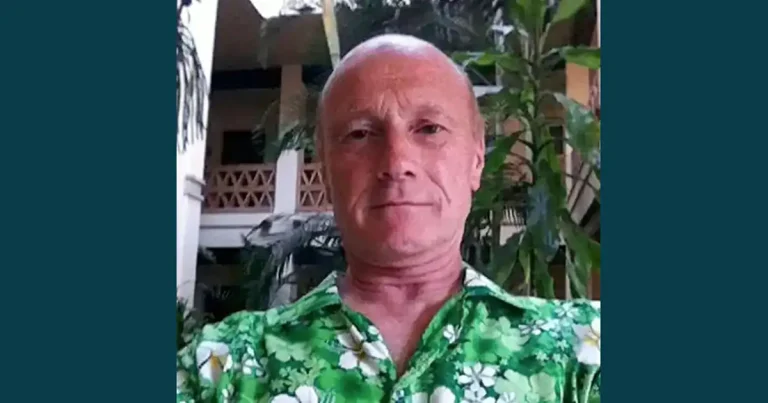 Jon Ruben, photographed outdoors in a tropical-style setting, wearing a green floral shirt.