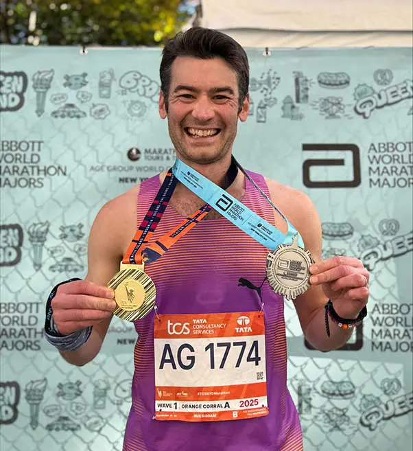 Nick Weston with two medals at New York City marathon.
